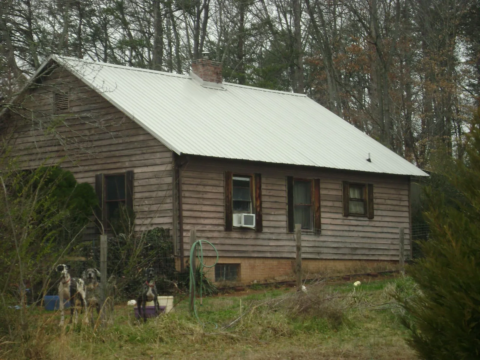 White metal roof on an old wood sided farmhouse, from a Metal Roof Installation job in Merry Hill